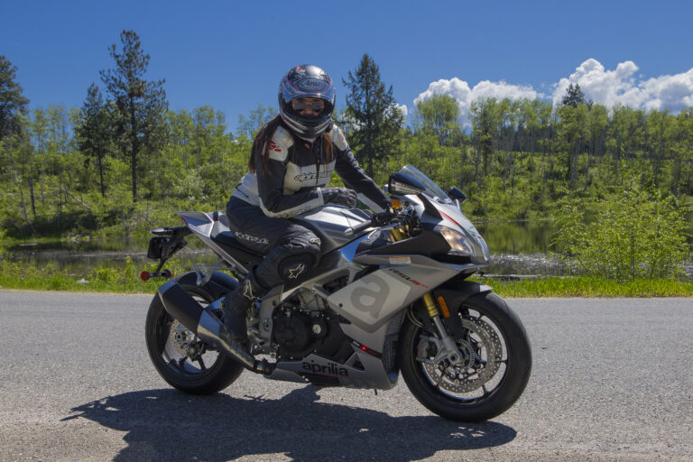 A motorcyclist seated on an Aprilia RSV4 sport bike