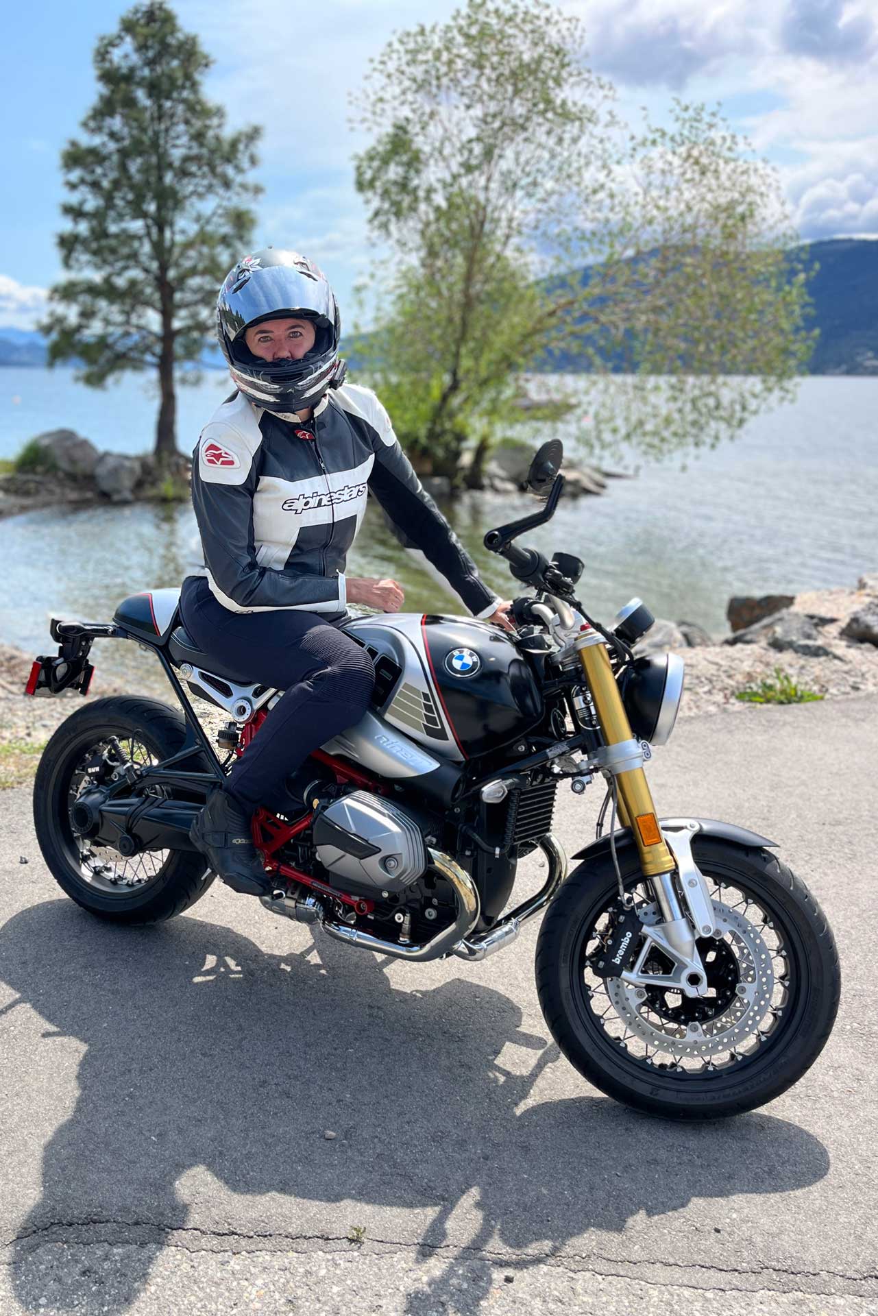 Female rider seated on a 2023 BMW R NineT motorycle