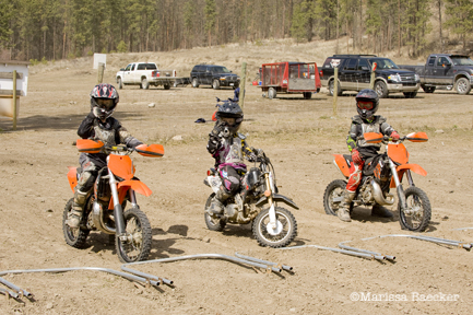 Three young riders take part in motocross lessons