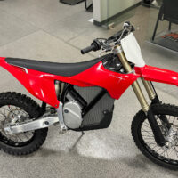 The VARG motocross bike from Stark Future stands in a showroom,