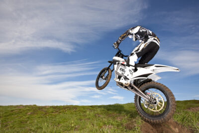 An electric Zero motorcycle jumps in the dirt