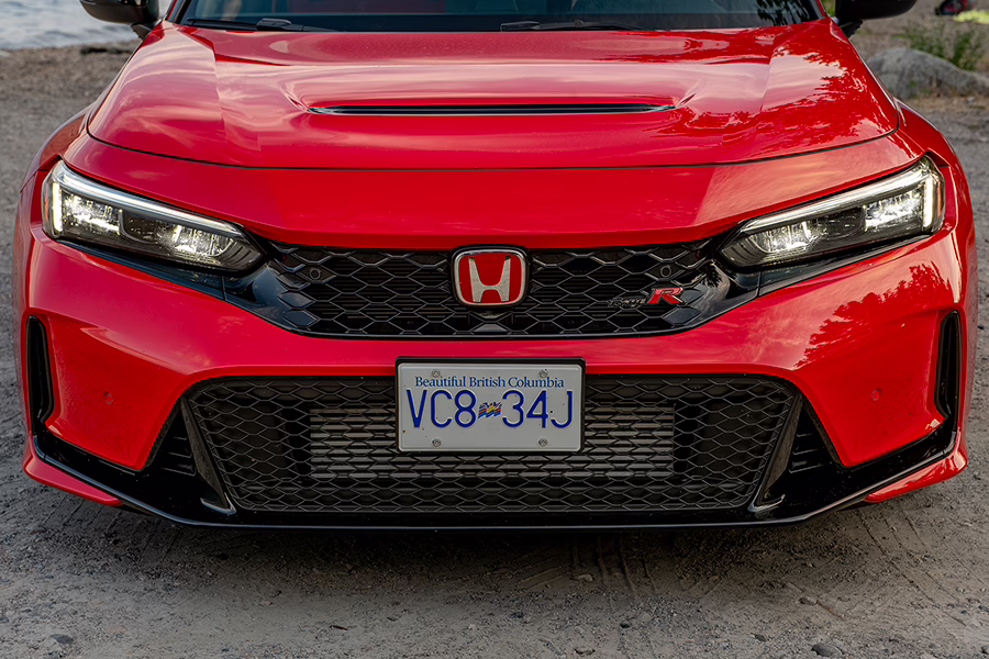 front spoiler, headlights and hood of a red sportscar