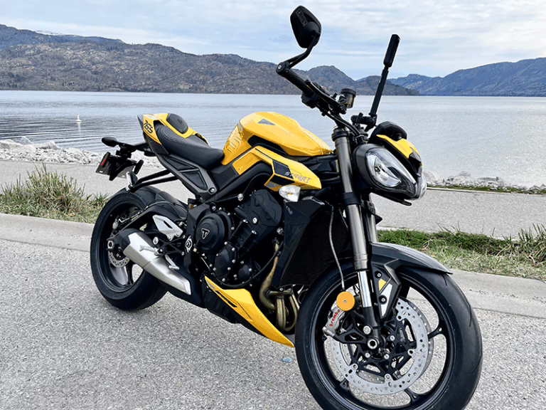 a motorcycle parked beside a lake