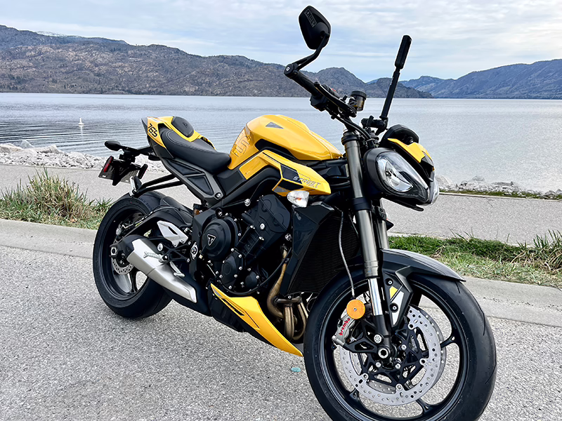 a motorcycle parked beside a lake