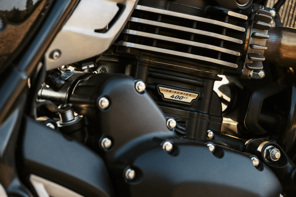 Triumph Unveils the All New 2026 Scrambler 400 XC 11 a close up view of a single cylinder air cooled engine of a motorcycle with a name plate that reads 400 XC