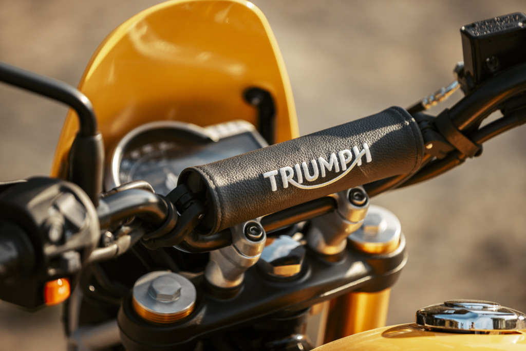 Triumph Unveils the All New 2026 Scrambler 400 XC 14 a close up view of the handlebar wrap on a motorcycle that reads Triumph