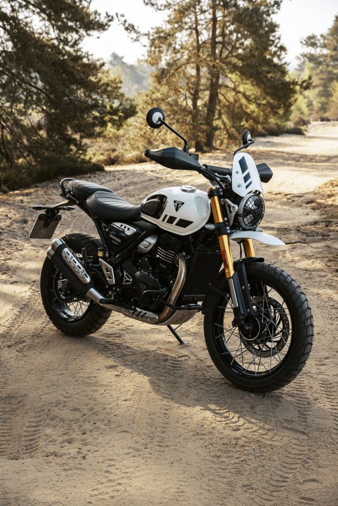 Triumph Unveils the All New 2026 Scrambler 400 XC 15 a white motorcycle parked on a gravel road