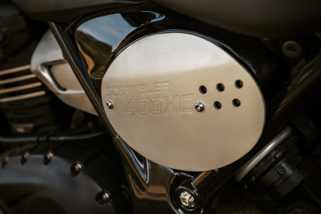 Triumph Unveils the All New 2026 Scrambler 400 XC 16 a race plate of an motorcycle debossed with the words Scrambler 400 XC
