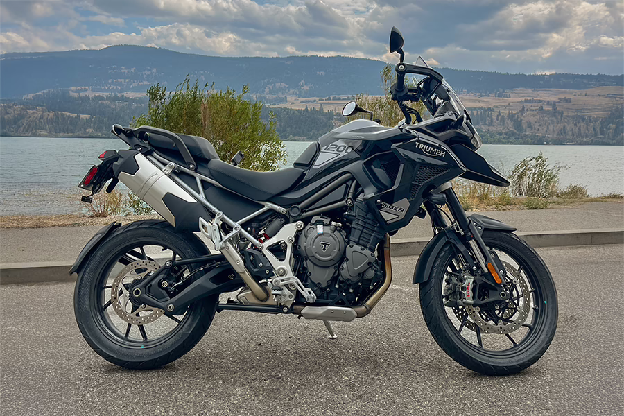 Triumph Tiger 1200 Motorcycle parked beside a lake