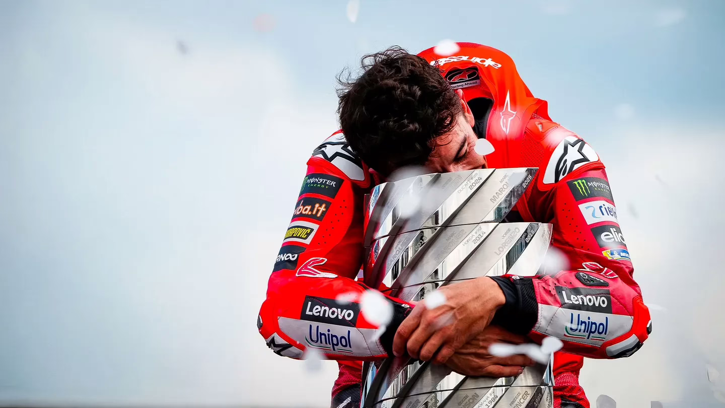 marc marquez hugs the moto gp trophy