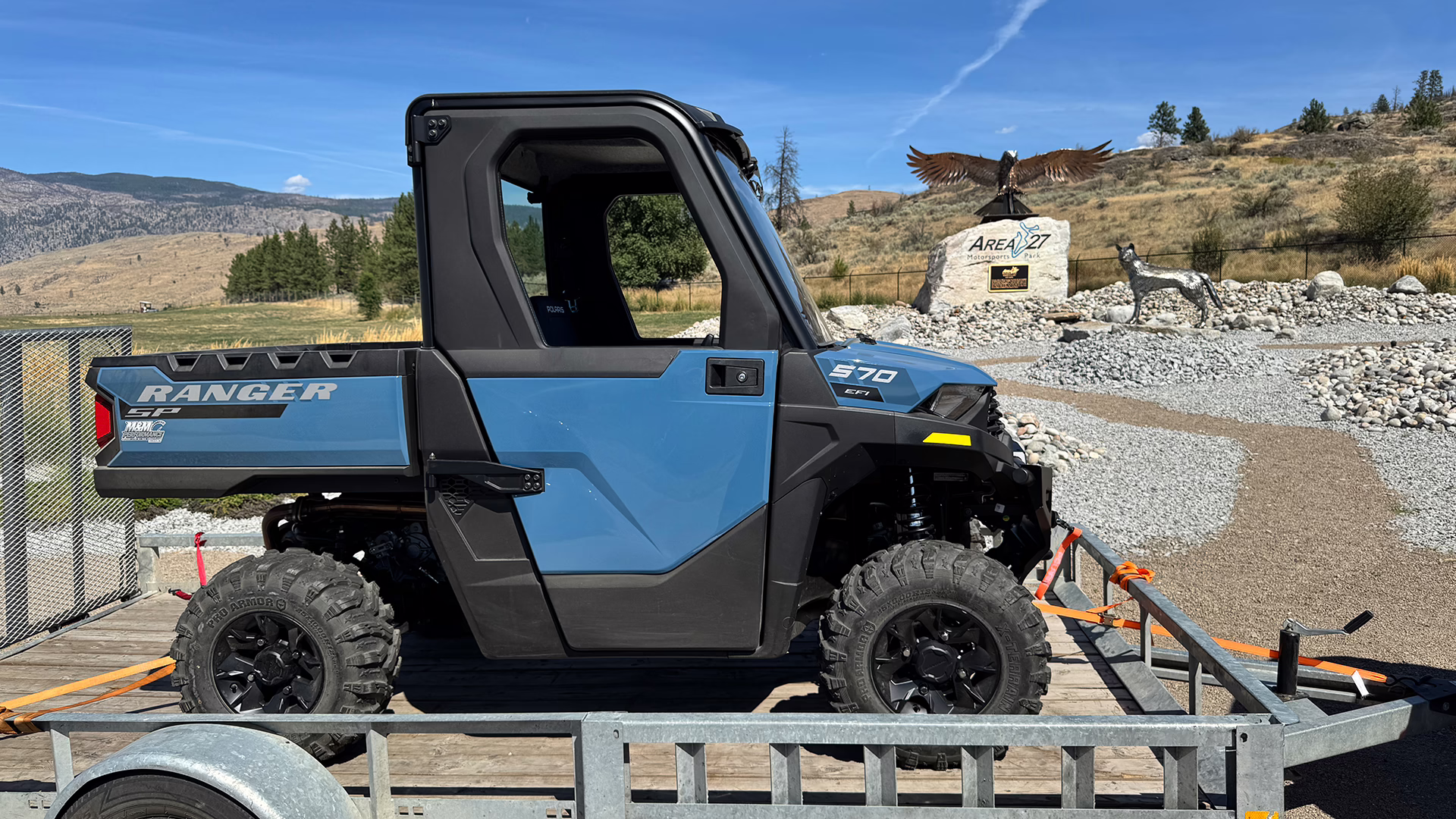 a blue Polaris Ranger 570 Northstar side by side on a trailer